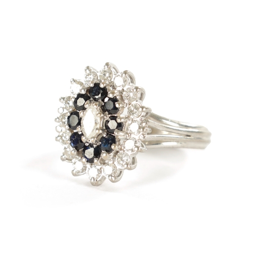 387 - AN 18CT WHITE GOLD SAPPHIRE AND DIAMOND RING with a navette cut centre diamond surrounded by eight b... 