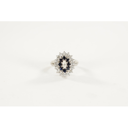 387 - AN 18CT WHITE GOLD SAPPHIRE AND DIAMOND RING with a navette cut centre diamond surrounded by eight b... 