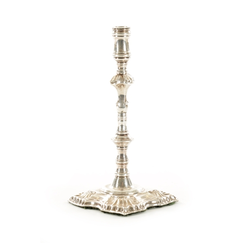 392 - A GEORGIAN CAST SILVER SLENDER CANDLESTICK with square shelled base and ringed stem, 160g (15.5cm hi... 