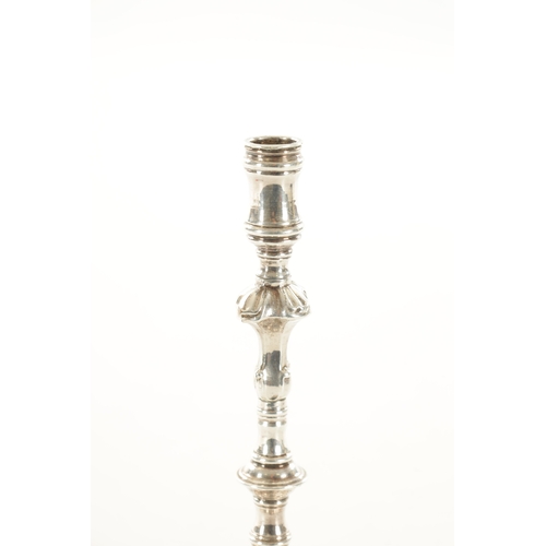 392 - A GEORGIAN CAST SILVER SLENDER CANDLESTICK with square shelled base and ringed stem, 160g (15.5cm hi... 