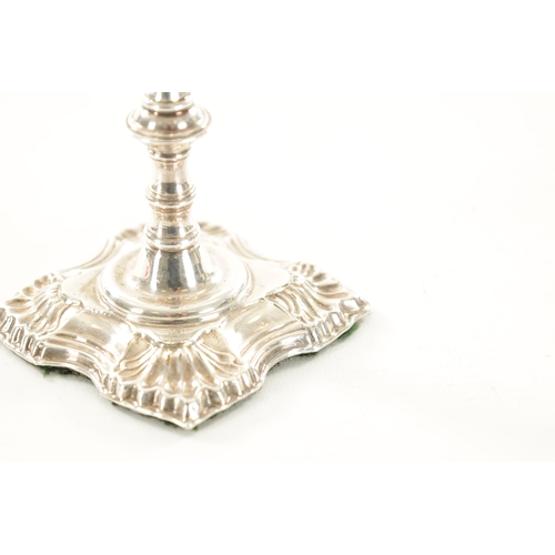 392 - A GEORGIAN CAST SILVER SLENDER CANDLESTICK with square shelled base and ringed stem, 160g (15.5cm hi... 