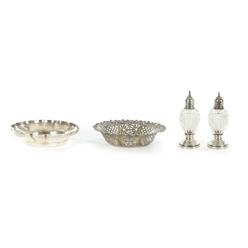 393 - TWO SILVER TRINKET DISHES AND A PAIR OF SILVER MOUNTED GLASS SHAKERS (11cm diameter)