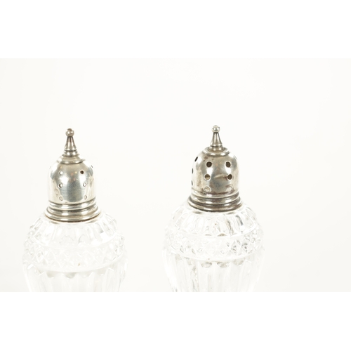 393 - TWO SILVER TRINKET DISHES AND A PAIR OF SILVER MOUNTED GLASS SHAKERS (11cm diameter)