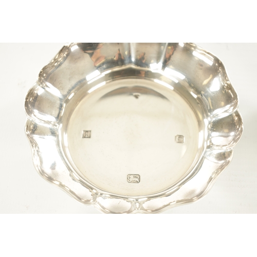 393 - TWO SILVER TRINKET DISHES AND A PAIR OF SILVER MOUNTED GLASS SHAKERS (11cm diameter)