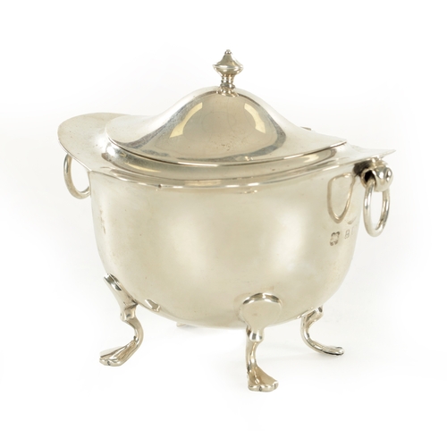 394 - A SMALL EDWARDIAN SILVER FOOTED OVAL LIDDED TEA CADDY with flared shaped top rim, two ring handles r... 