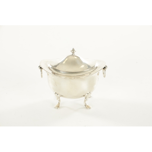 394 - A SMALL EDWARDIAN SILVER FOOTED OVAL LIDDED TEA CADDY with flared shaped top rim, two ring handles r... 