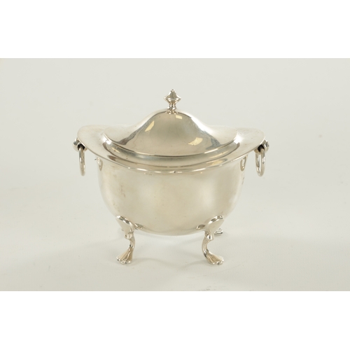 394 - A SMALL EDWARDIAN SILVER FOOTED OVAL LIDDED TEA CADDY with flared shaped top rim, two ring handles r... 