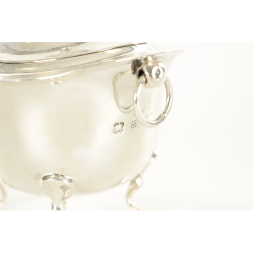 394 - A SMALL EDWARDIAN SILVER FOOTED OVAL LIDDED TEA CADDY with flared shaped top rim, two ring handles r... 