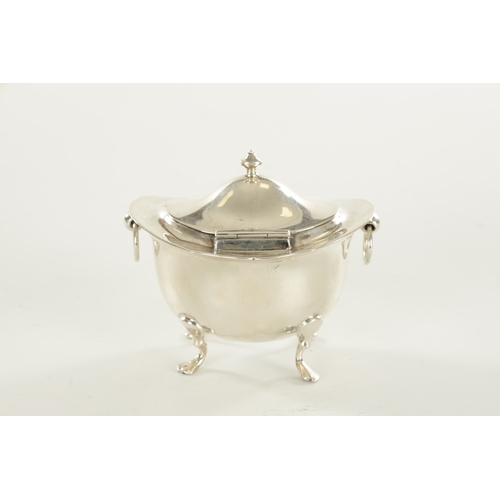 394 - A SMALL EDWARDIAN SILVER FOOTED OVAL LIDDED TEA CADDY with flared shaped top rim, two ring handles r... 