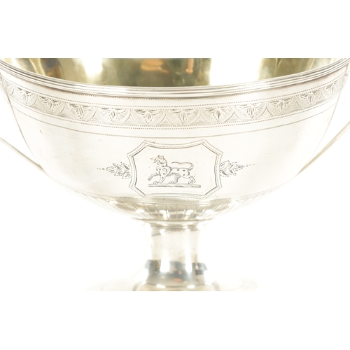 396 - A GEORGE III SILVER SUGAR BASKET with arcaded border, armorial panels and reeded decoration; raised ... 