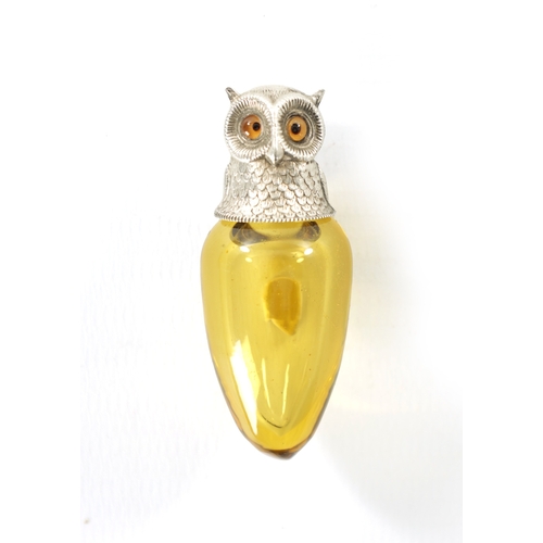398 - A FINE VICTORIAN SILVER MOUNTED AMBER GLASS OWL SCENT BOTTLE the cone shaped body with finely sculpt... 