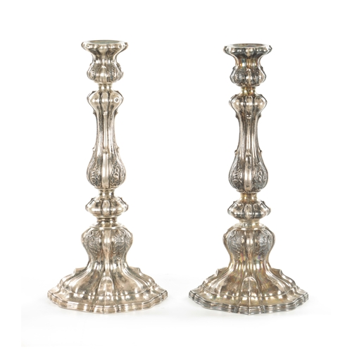 405 - A PAIR OF CONTINENTAL SILVER CANDLESTICKS with bulbous leaf cast stems and shelled base, 530g (30cm ... 