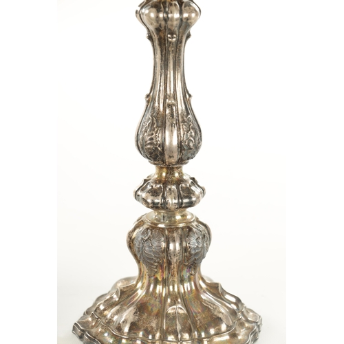 405 - A PAIR OF CONTINENTAL SILVER CANDLESTICKS with bulbous leaf cast stems and shelled base, 530g (30cm ... 