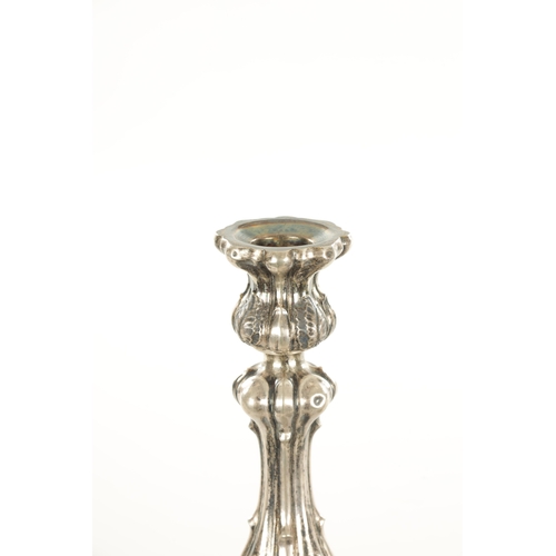 405 - A PAIR OF CONTINENTAL SILVER CANDLESTICKS with bulbous leaf cast stems and shelled base, 530g (30cm ... 