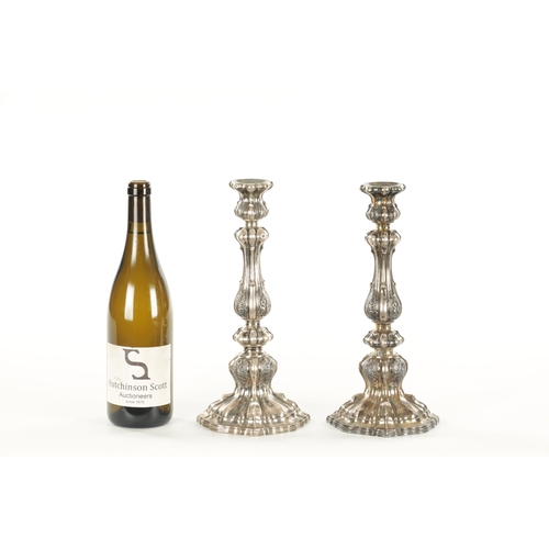 405 - A PAIR OF CONTINENTAL SILVER CANDLESTICKS with bulbous leaf cast stems and shelled base, 530g (30cm ... 