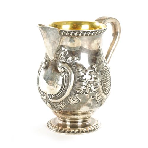 408 - A TIFFANY AND CO 550 BROADWAY SILVER MILK JUG with gadroon rims, gilt interior and embossed leafing ... 