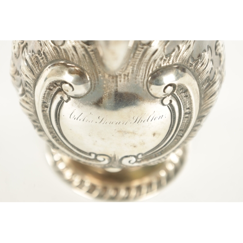 408 - A TIFFANY AND CO 550 BROADWAY SILVER MILK JUG with gadroon rims, gilt interior and embossed leafing ... 