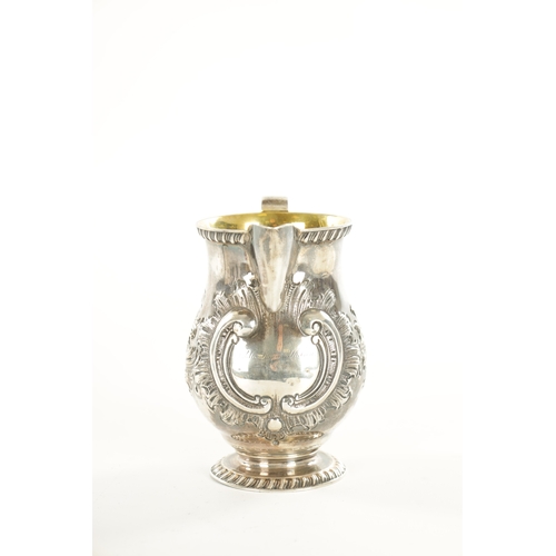 408 - A TIFFANY AND CO 550 BROADWAY SILVER MILK JUG with gadroon rims, gilt interior and embossed leafing ... 