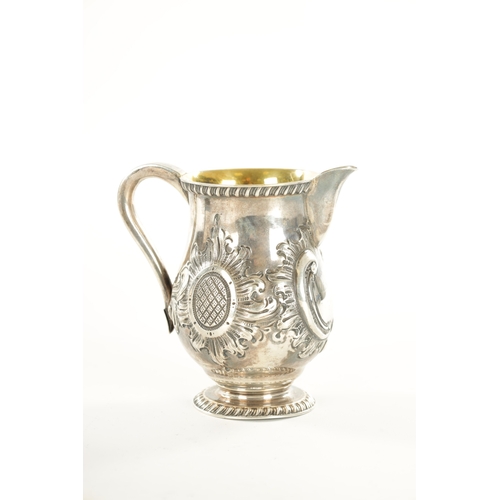 408 - A TIFFANY AND CO 550 BROADWAY SILVER MILK JUG with gadroon rims, gilt interior and embossed leafing ... 