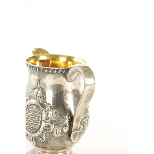 408 - A TIFFANY AND CO 550 BROADWAY SILVER MILK JUG with gadroon rims, gilt interior and embossed leafing ... 