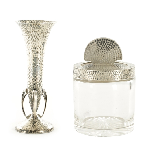 420 - AN ARTS AND CRAFTS SILVER POSY VASE AND MATCHING LIDDED GLASS JAR both of hammered design, the vase ... 