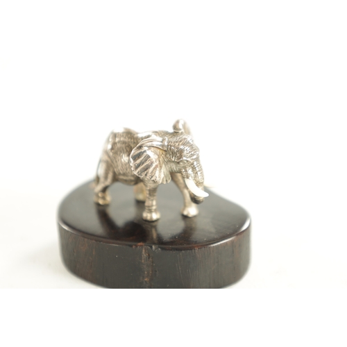 438 - TWO PATRICK MAVROSS MINIATURE SILVER SCULPTURES formed as a Rhinoceros and an Elephant having white ... 