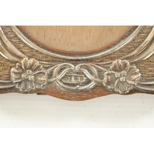 439 - AN ART NOUVEAU SILVER FRAME with shaped border depicting flowerhead amongst branchwork, Birmingham, ... 