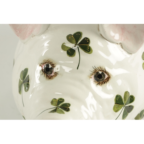 44 - A LATE 19TH CENTURY OVERSIZED WEMYSS PIG realistically modelled in a seated pose decorated with gree... 