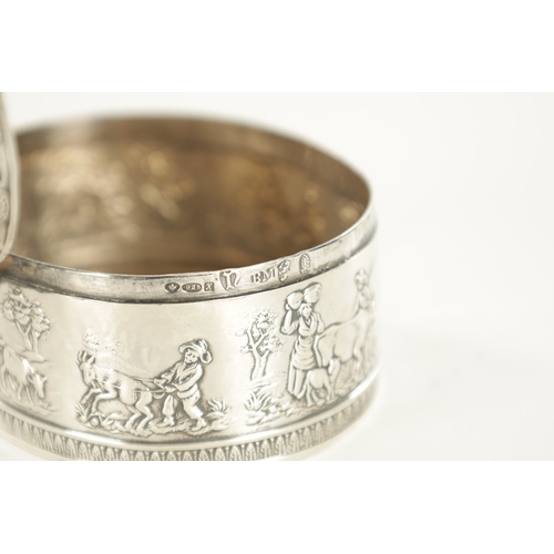 443 - A SMALL 19TH CENTURY DUTCH SILVER OVAL TRINKET BOX embossed with figural farming scenes to the rim, ... 