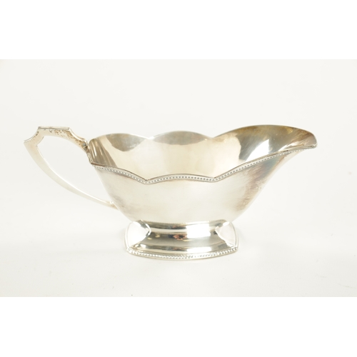 444 - A GEORGE VI BOXED SILVER SAUCE BOAT with gadrooned borders and shaped handle by Samson & Mordan, Bir... 