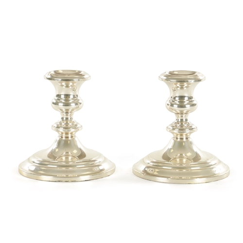 445 - A PAIR OF FILLED SILVER CANDLESTICKS BY GORHAM of squat ringed form with moulded circular bases (12c... 