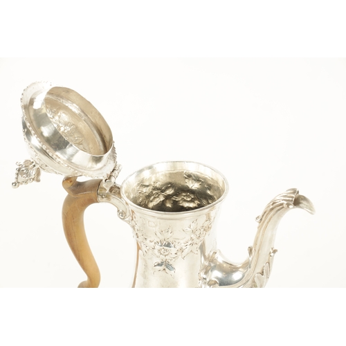 453 - A GEORGE III SILVER COFFEE POT the footed baluster body with leaf-capped scroll spout, shaped pearwo... 