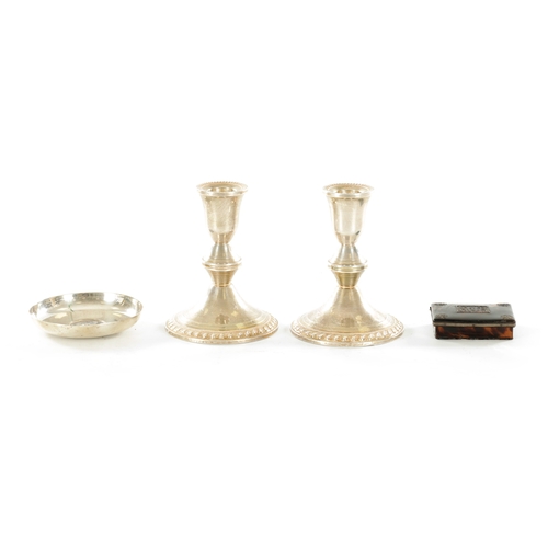 454 - A PAIR OF STERLING SILVER SHORT CIRCULAR BASE CANDLESTICKS with feathered borders and knopped stems ... 