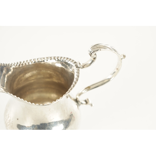 458 - A GEORGE III SILVER FOOTED CREAM JUG bulbous body with beaded rims and scrolling handle, London, 181... 