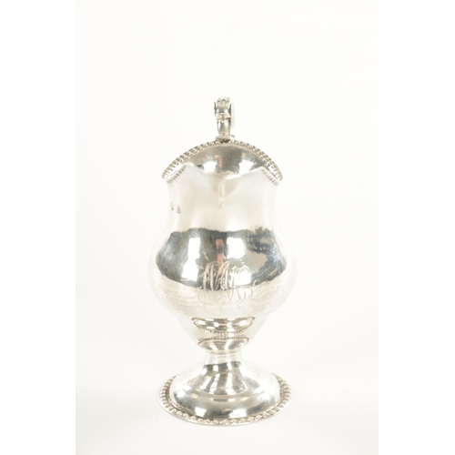 458 - A GEORGE III SILVER FOOTED CREAM JUG bulbous body with beaded rims and scrolling handle, London, 181... 