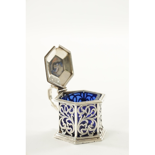 461 - A VICTORIAN SILVER AND BLUE GLASS HEXAGONAL LIDDED MUSTARD POT with pierced scroll decoration by Cha... 