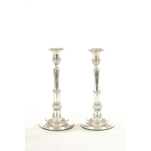 465 - A PAIR OF EARLY 19TH CENTURY SILVER TELESCOPIC CANDLESTICKS having circular bases with adjustable st... 