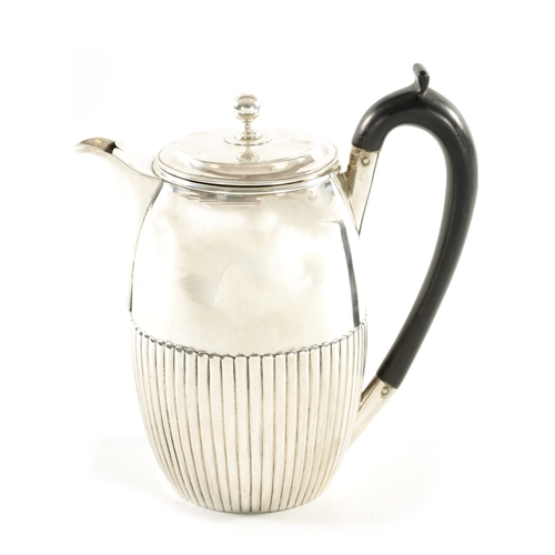 476 - A GEORGE III SILVER CHOCOLATE POT with shaped lid above a reeded body and shaped ebonised handle. Lo... 