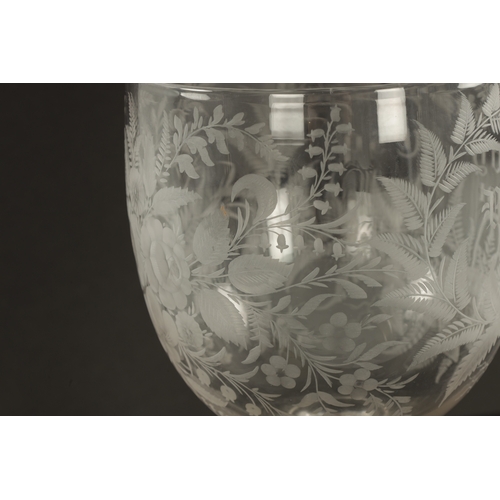 5 - AN OVERSIZED LATE 19TH CENTURY ENGRAVED GLASS COIN GOBLET the body having floral decoration and insc... 