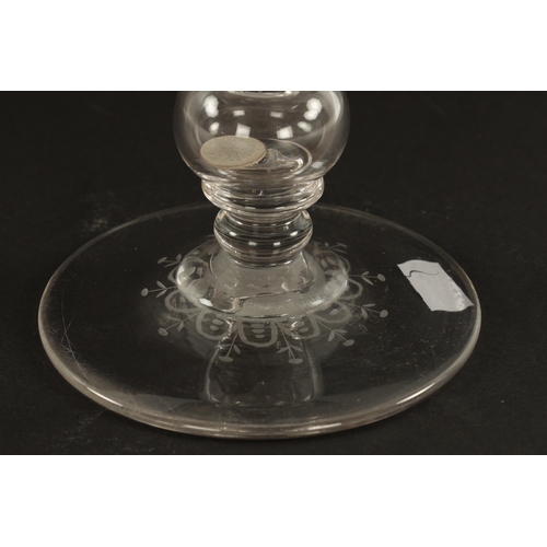 5 - AN OVERSIZED LATE 19TH CENTURY ENGRAVED GLASS COIN GOBLET the body having floral decoration and insc... 