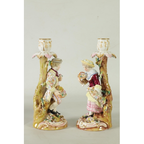 55 - A PAIR OF 19TH CENTURY JOHN BEVINGTON FLORALLY ENCRUSTED FIGURAL CANDLESTICKS finely detailed and de... 