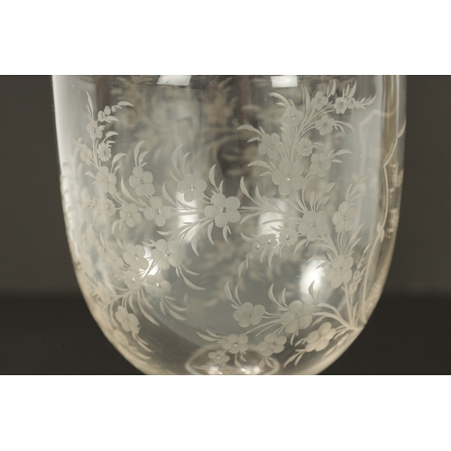 6 - A LARGE 19TH CENTURY ENGRAVED GLASS COIN GOBLET the body with floral decoration and centre cartouche... 