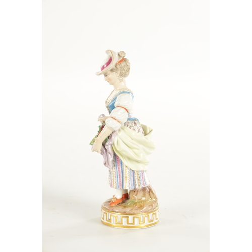 63 - A 19TH CENTURY MEISSEN FLOWER SELLER FIGURINE the colourful standing young lady displaying flower ga... 