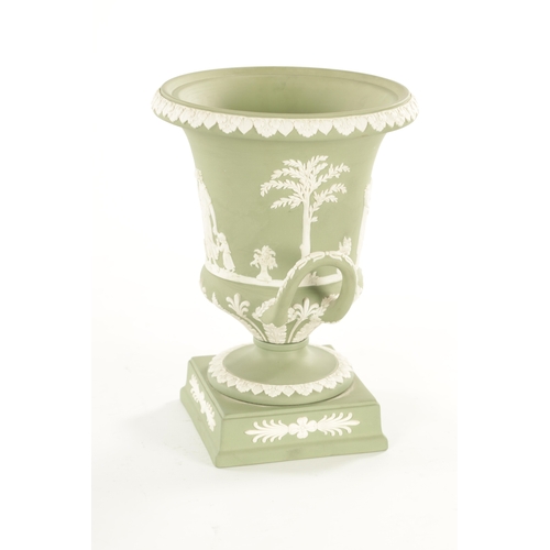 65 - A WEDGWOOD GREEN JASPER WARE TWO-HANDLED URN SHAPED VASE AND COVER ON PEDESTAL BASE decorated with a... 