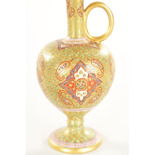 67 - A 19TH CENTURY PERSIAN STYLE CERAMIC EWER of footed bulbous form with triple pouring spout to the lo... 
