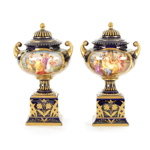 70 - A PAIR OF LATE 19TH CENTURY ROYAL BLUE AND GILT VIENNA STYLE LIDDED VASES the two-handled urn-shaped... 