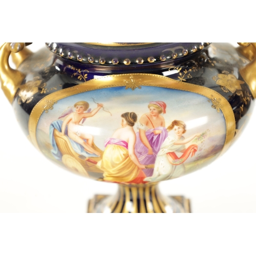 70 - A PAIR OF LATE 19TH CENTURY ROYAL BLUE AND GILT VIENNA STYLE LIDDED VASES the two-handled urn-shaped... 