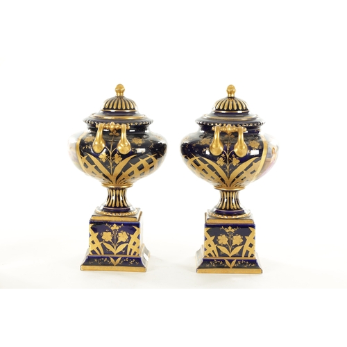 70 - A PAIR OF LATE 19TH CENTURY ROYAL BLUE AND GILT VIENNA STYLE LIDDED VASES the two-handled urn-shaped... 