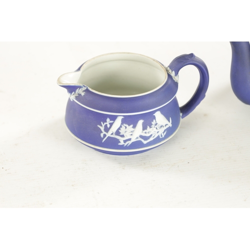 82 - A WEDGWOOD THREE-PIECE BIRD PATTERN TEASET comprising a teapot, sugar bowl and cream jug. (Teapot is... 