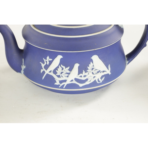 82 - A WEDGWOOD THREE-PIECE BIRD PATTERN TEASET comprising a teapot, sugar bowl and cream jug. (Teapot is... 